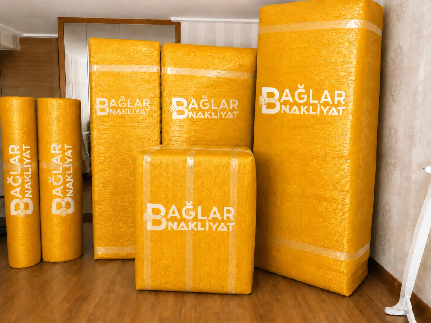 Bir odada koruyucu malzemeyle sarılmış büyük ev eşyaları