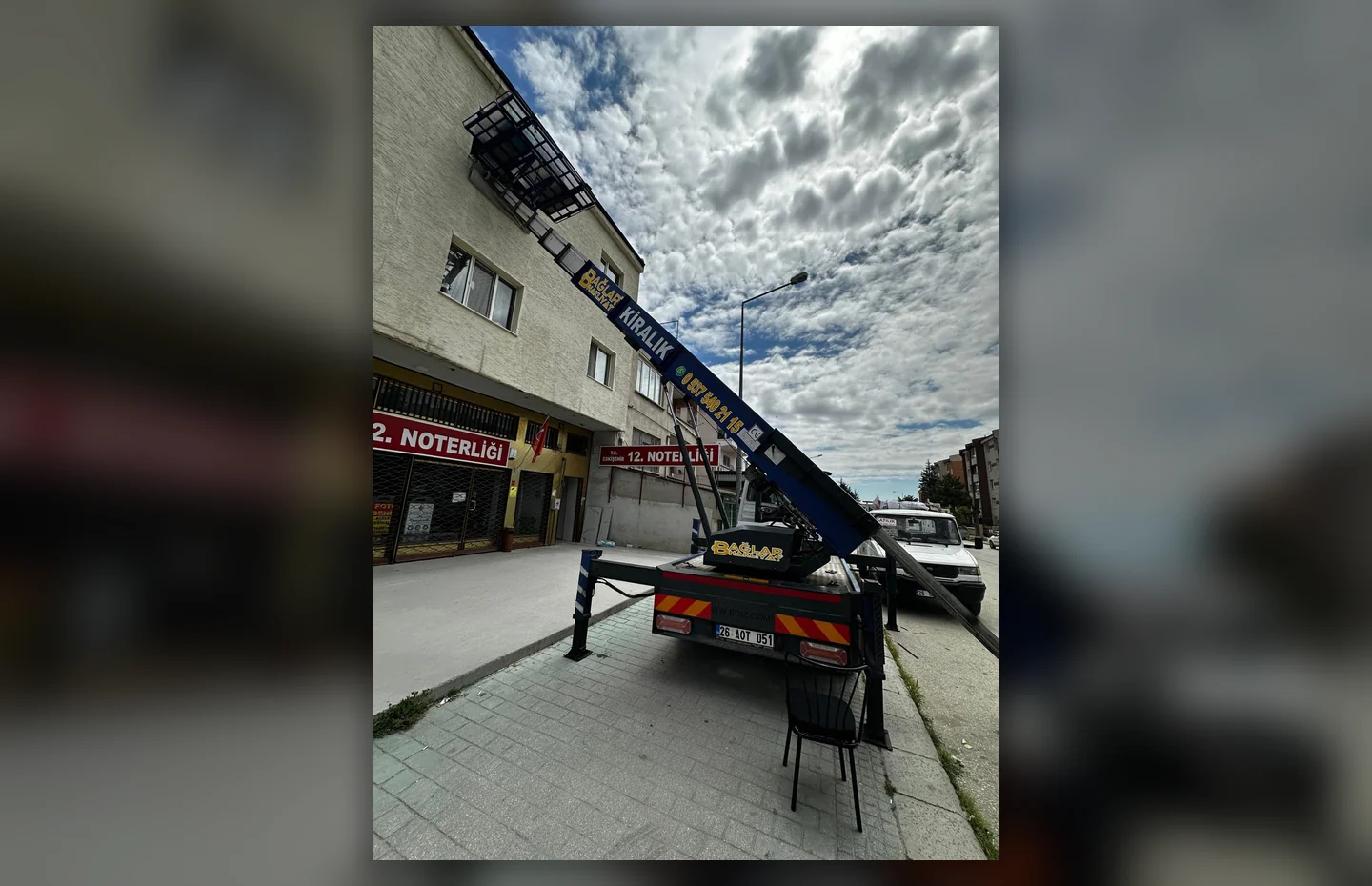 Bina cephesinde çalışan taşıma asansörü ve Bağlar Nakliyat aracı